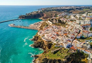 Aerial view of marina and white architecture above cliffs in Albufeira, Algarve, Portugal